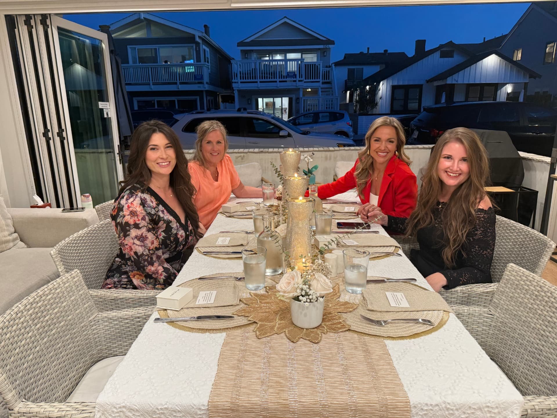 Women seated together at the candlelit commissioning dinner during the 2026 Newport Beach retreat