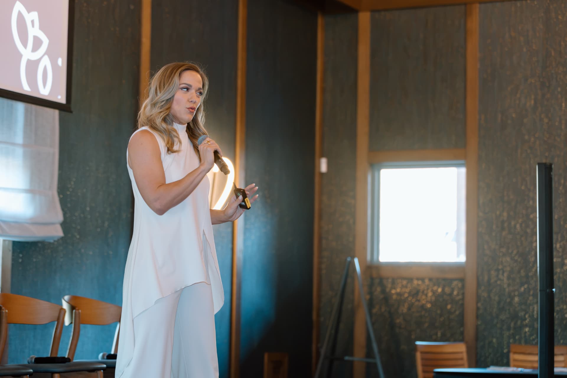 Molly Gomez teaching, microphone in hand